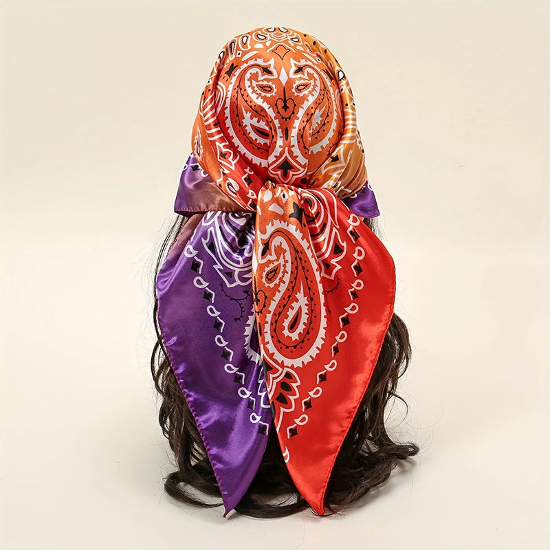 A vibrant orange and purple satin silk scarf tied around dark hair.