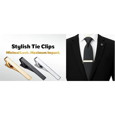 A close-up of a gold elegant men's tie clip resting on a white shirt and black suit jacket.