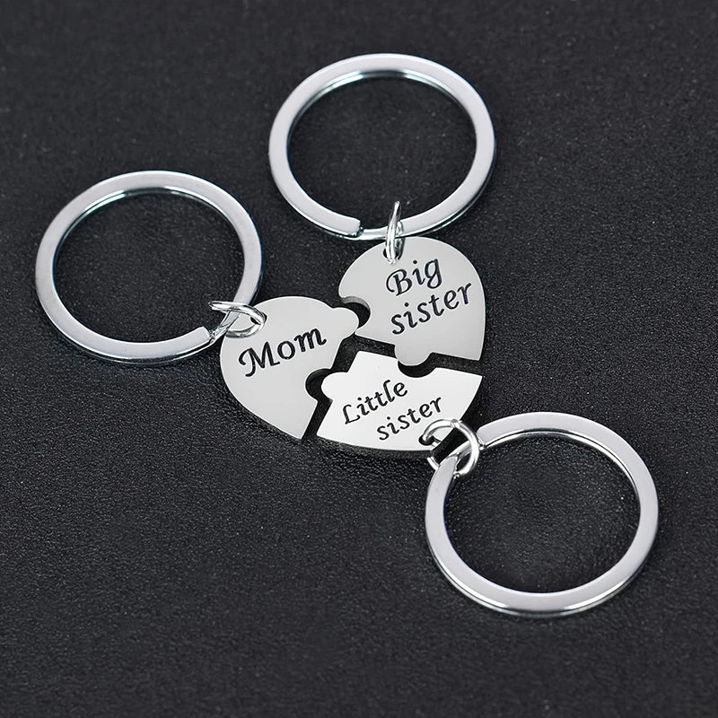 Silver keychain set featuring puzzle heart charms labeled Mom, Big sister, and Little sister