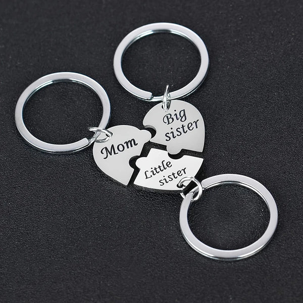 Silver keychain set featuring puzzle heart charms labeled Mom, Big sister, and Little sister