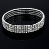 A close-up shot of a silver multi-layer crystal tennis anklet with pave-set diamonds, displayed on a dark reflective surface.