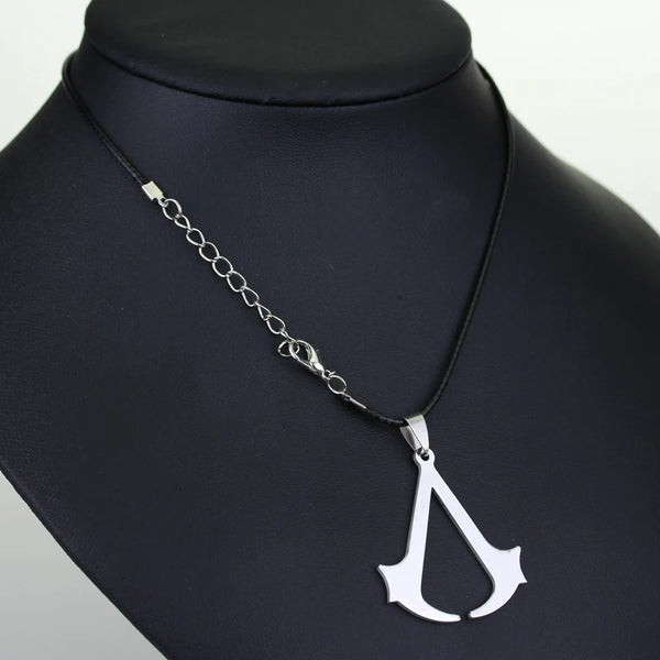 Stainless steel pendant necklace featuring an Assassin's Creed themed dagger design on a black velvet display.
