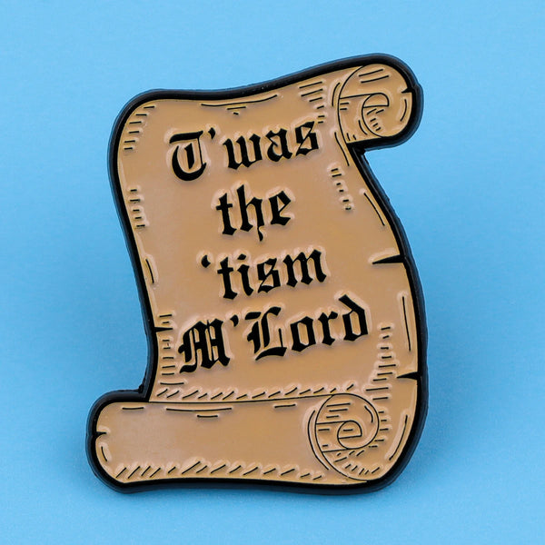 A vintage-style enamel pin featuring the text I was the tism M Lord in a decorative script.