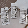 A set of vintage silver Y2K metal hair clips displayed on white cards.