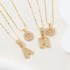 Gold initial letter necklace set featuring CZ crystal pendants for a couple