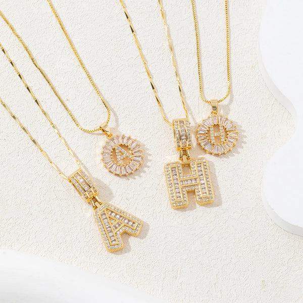 Gold initial letter necklace set featuring CZ crystal pendants for a couple