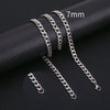 A set of silver stainless steel Cuban link necklaces of varying lengths displayed on a black fabric background.