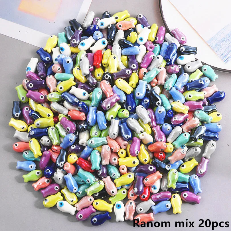 Assortment of ceramic fish charms in various colors and shapes for DIY jewelry making
