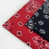 Two folded red and black patterned cotton bandana scarves displayed on a white surface.