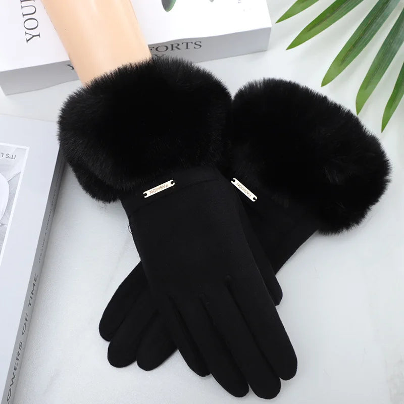 Black plush wrist gloves with faux fur cuffs displayed on a white surface.
