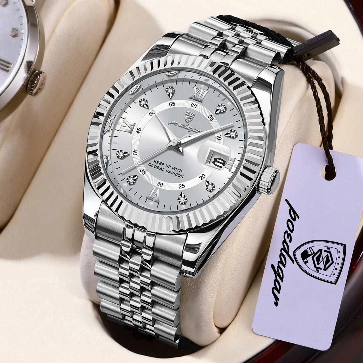 A silver-toned watch with a metal bracelet and a leather strap is displayed on a light background.