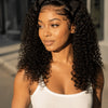 A woman modeling a natural Jerry curl lace front wig in a white tank top.