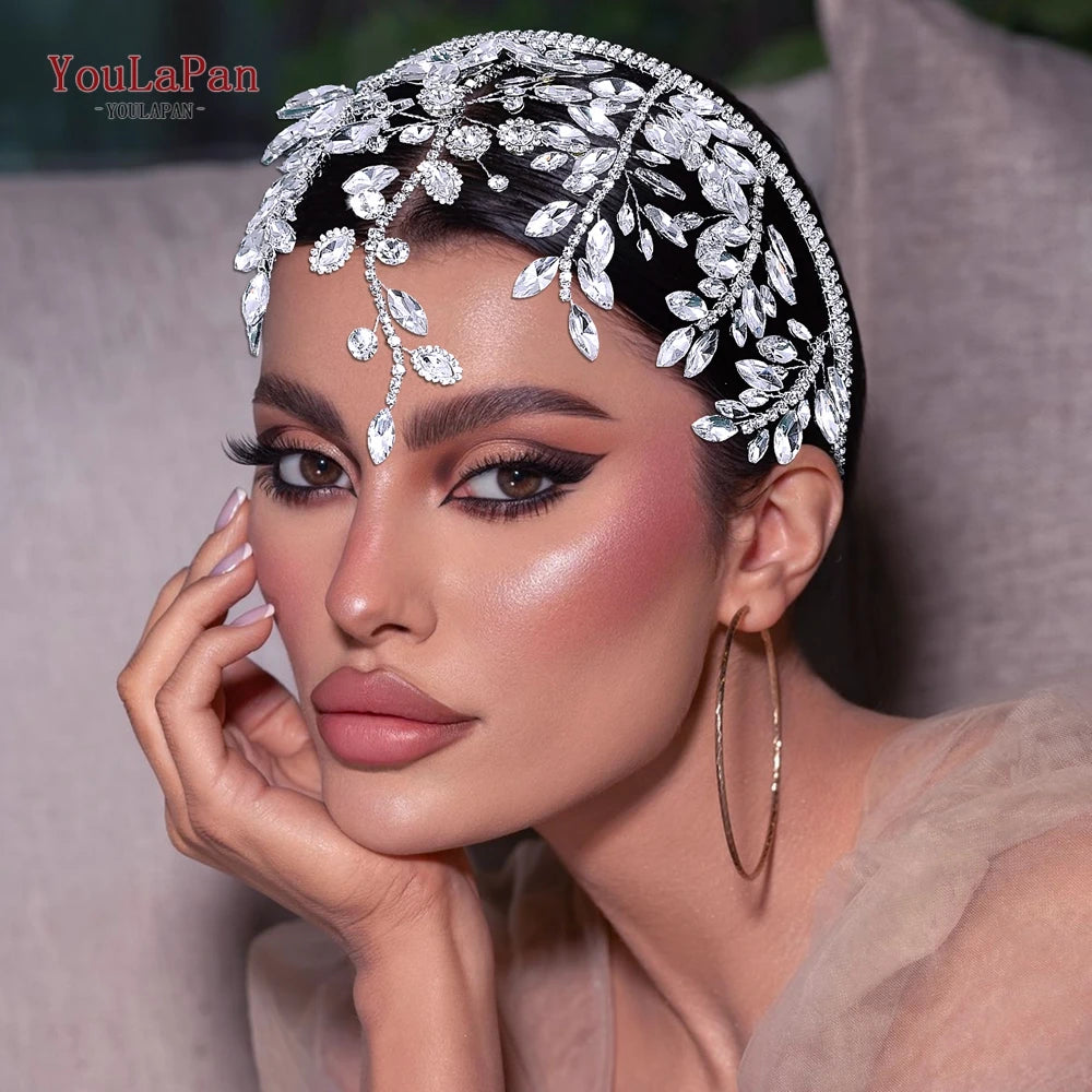 A close-up of a woman wearing a sparkling rhinestone bridal hair hoop adorned with floral elements.