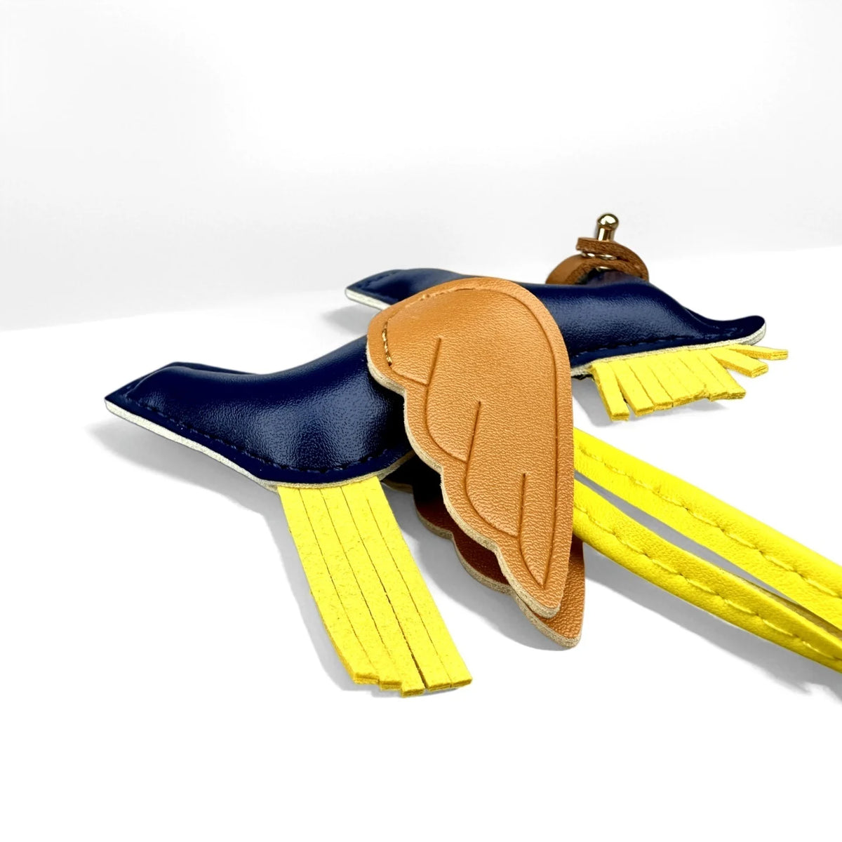 Elegant winged pony keychain featuring blue and gold fabric wings on a yellow strap