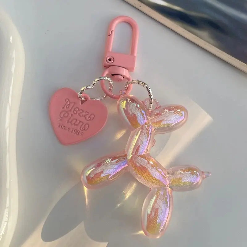 A pink jelly cartoon dog keychain with a heart tag and silver clasp.