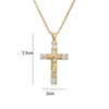 A dainty gold cross charm necklace featuring clear crystals and a pendant design.