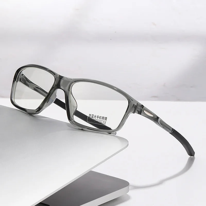 A pair of clear photochromic dual-light reading glasses resting on a white surface.