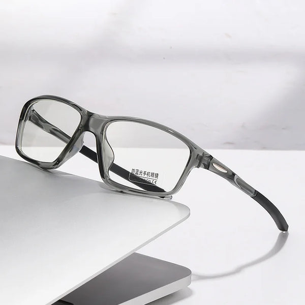 A pair of clear photochromic dual-light reading glasses resting on a white surface.