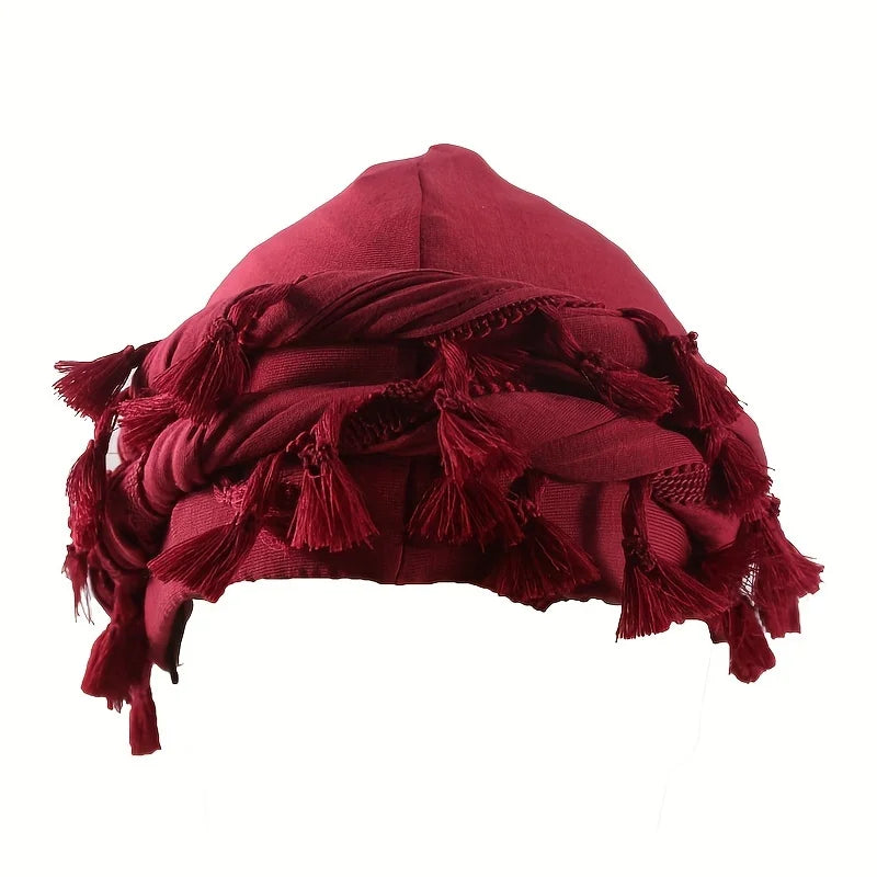 A deep maroon stretch modal and satin turban head wrap with fringed edges.