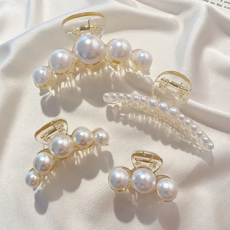 Clear acrylic hair claws adorned with small white simulated pearls
