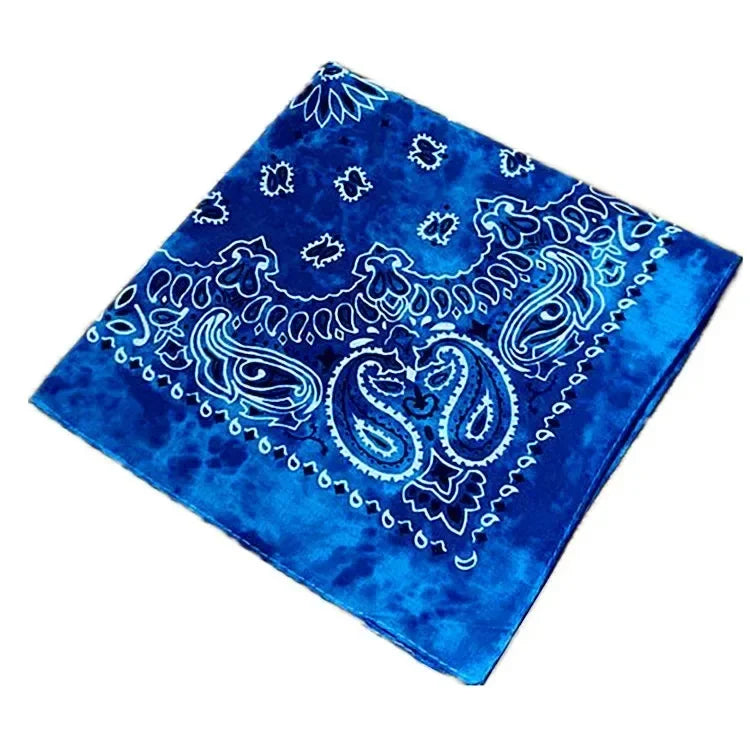 A vibrant blue cotton bandana scarf featuring white paisley and floral embroidery.