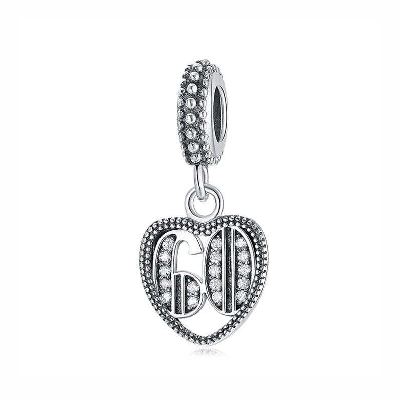 A silver family tree charm necklace featuring a detailed tree design and a textured bail.