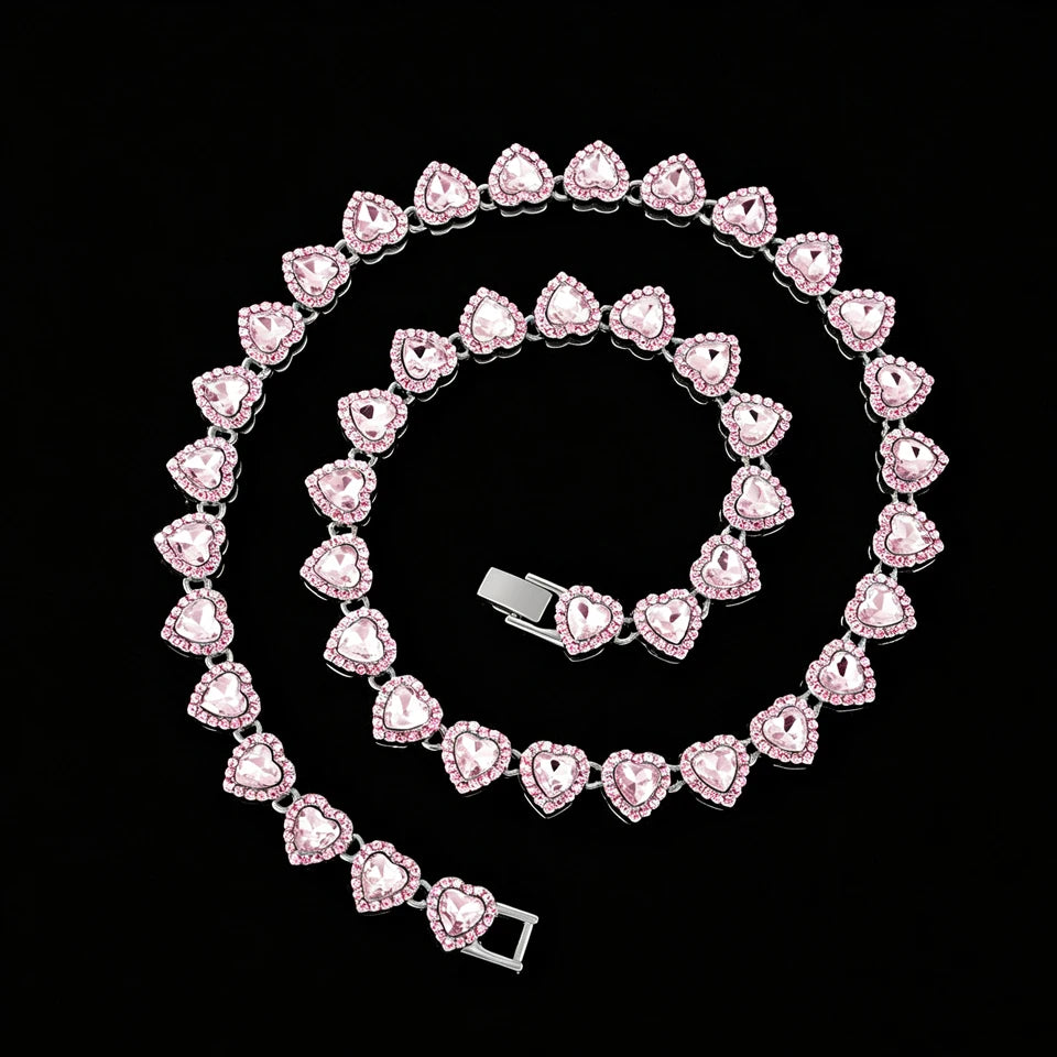 A spiral arrangement of pink heart-shaped rhinestones forming a necklace and bracelet set.