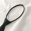 A black clip-on tie is shown against a white background.