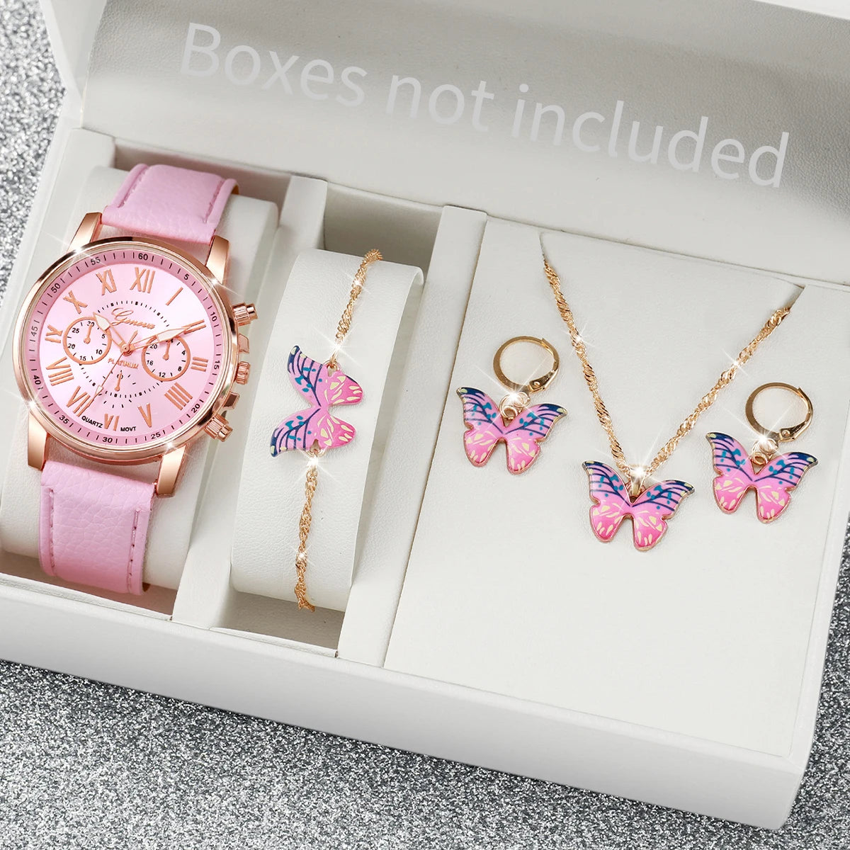 A pink fashion quartz wristwatch with a leather strap and several butterfly-shaped gold necklaces is displayed in an open box