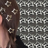 A close-up of a person's hair adorned with silver star metal snap clips.