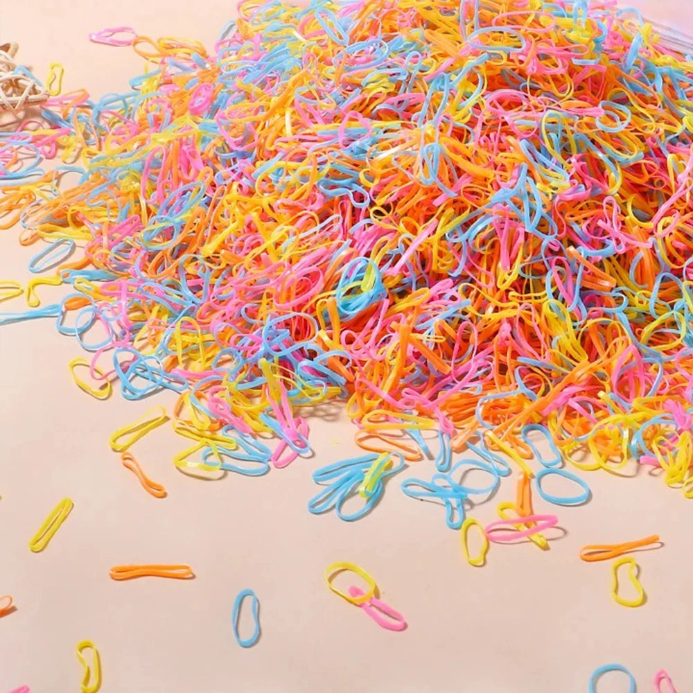 A pile of colorful disposable rubber hair ties in various bright colors like pink, orange, yellow, and blue.