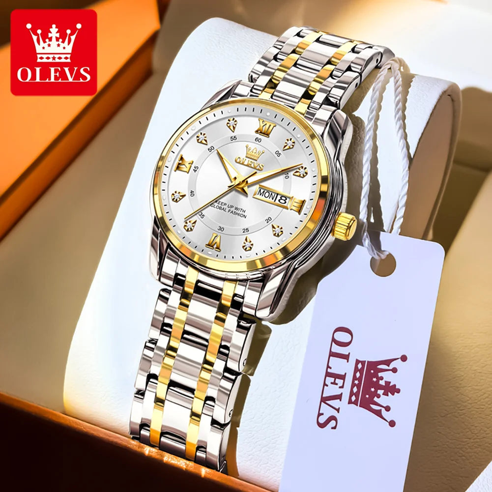 A stainless steel watch with a gold-toned bezel and silver bracelet is displayed in a box.