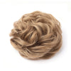 A bundle of light brown, wispy hair used for a messy bun or curly updo.