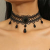 A black lace choker necklace featuring a central dark stone surrounded by intricate netting and dangling teardrop beads.