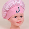Pink sleep cap for kids with a letter J embroidered on the front