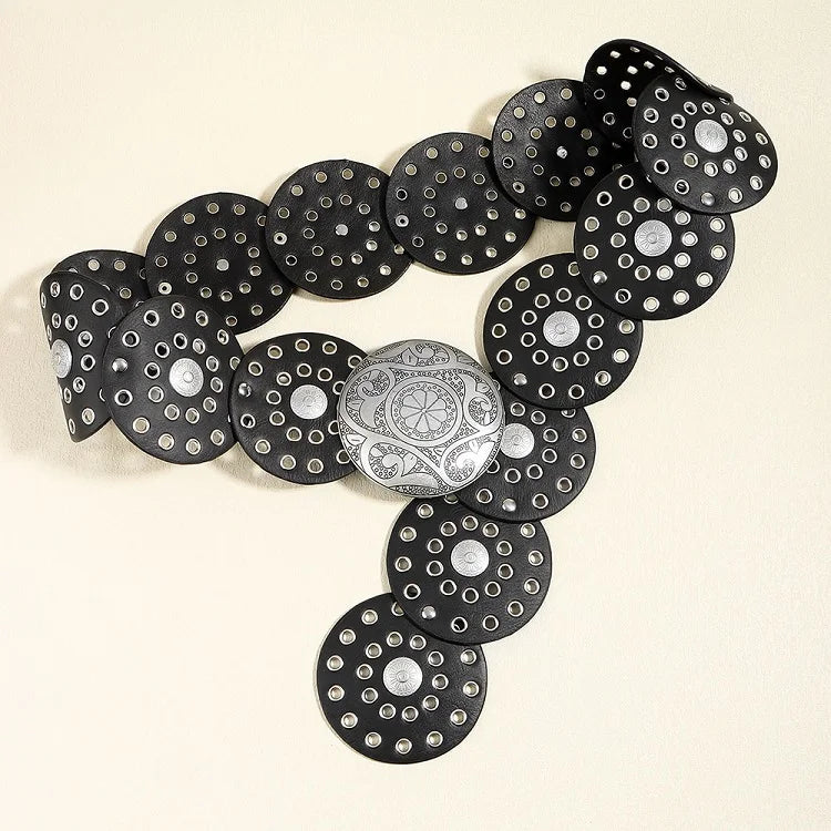 A black denim belt featuring silver studs and decorative metal discs.