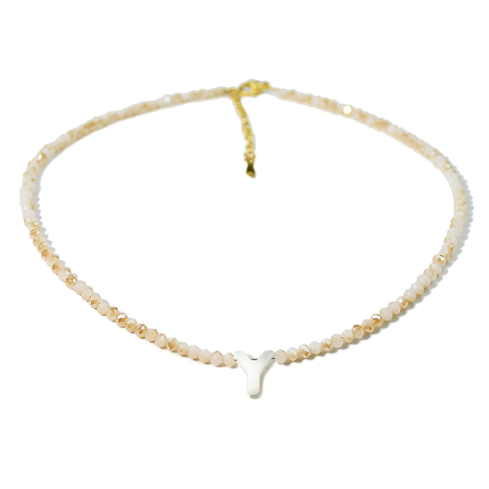 A delicate necklace featuring mother of pearl beads and crystal accents.