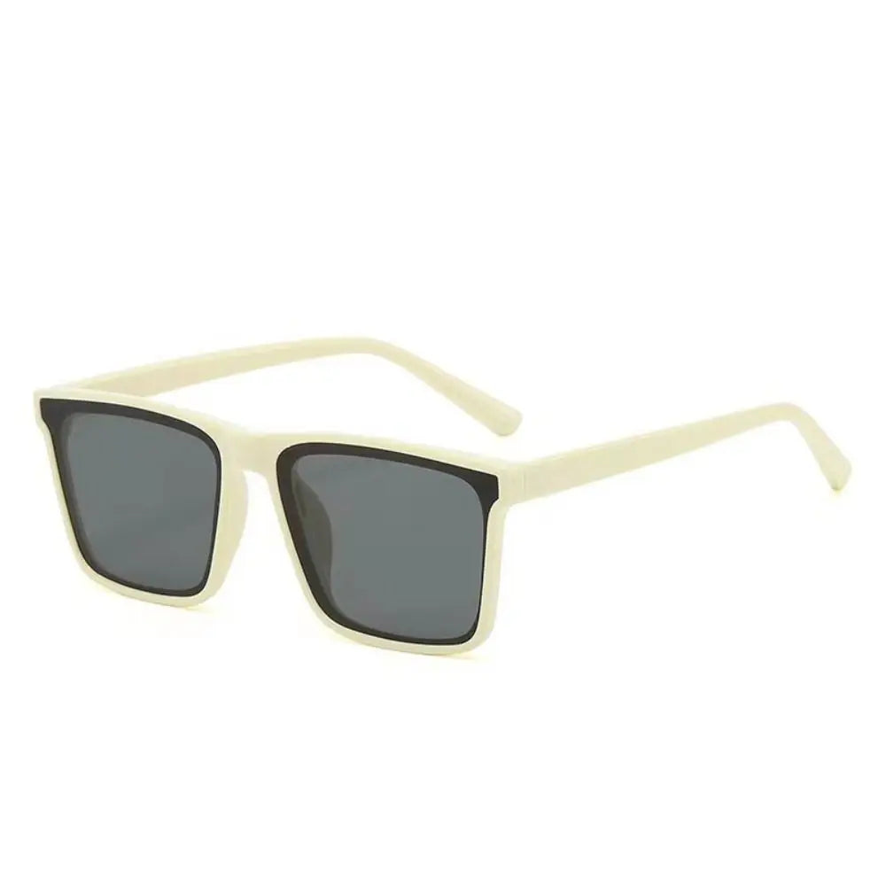 A pair of light beige square frame sunglasses with dark lenses.