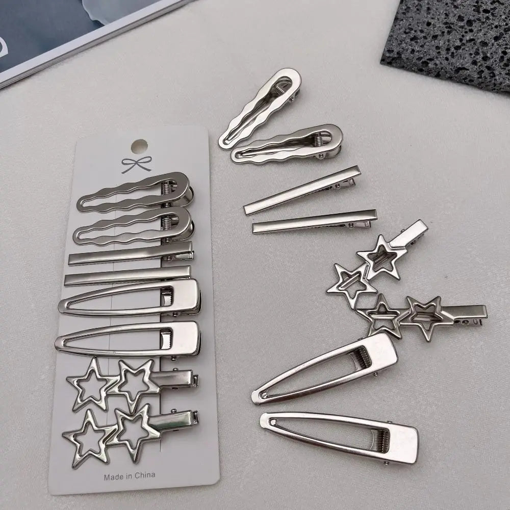 A set of vintage silver Y2K metal hair clips and barrettes displayed on a light gray surface.