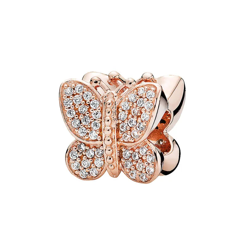 Rose gold cherry blossom charm pendant featuring pave-set clear stones.