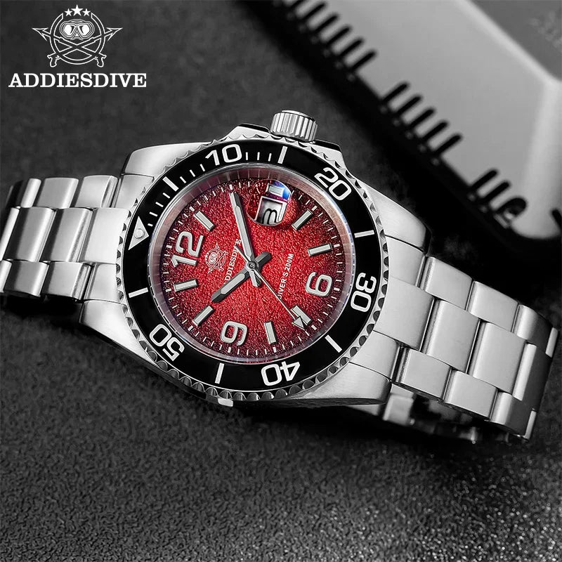 A silver diving quartz wristwatch with a red dial and black bezel is shown on a dark surface.