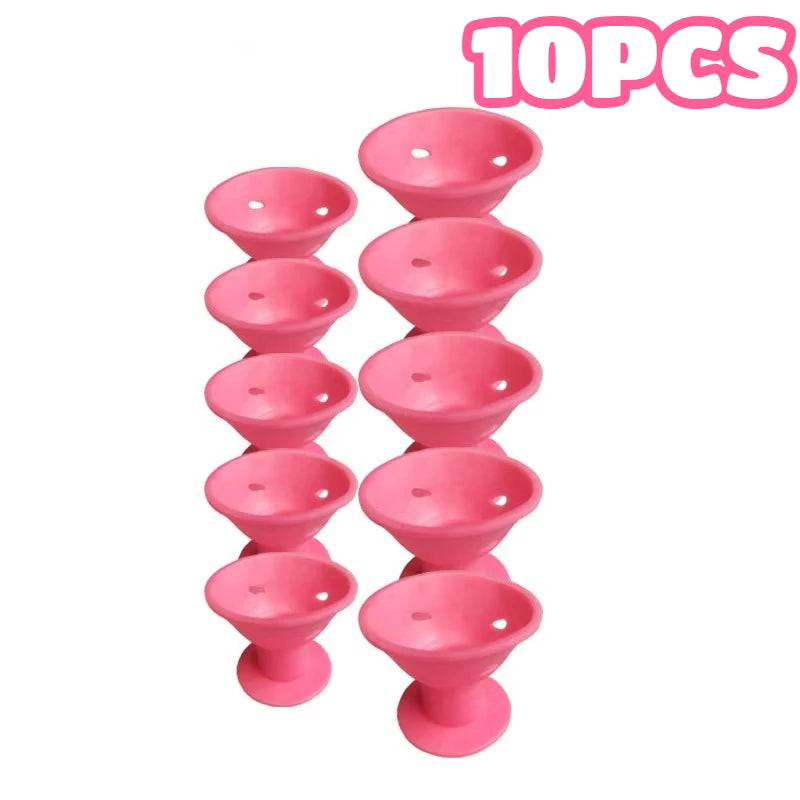 A set of ten pink heatless magic hair curlers for styling hair.