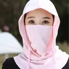 A woman wearing a pink lightweight sun protection hood covering her face.