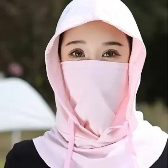 A woman wearing a pink lightweight sun protection hood covering her face.