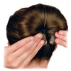 A hand is shown using an elegant gauze hair bun tool to style a dark brown hair bun.