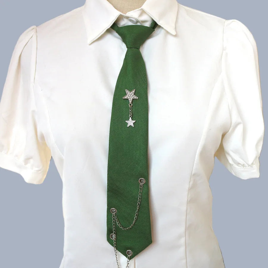 A white collared shirt with a dark green tie featuring a silver star pendant on a chain.