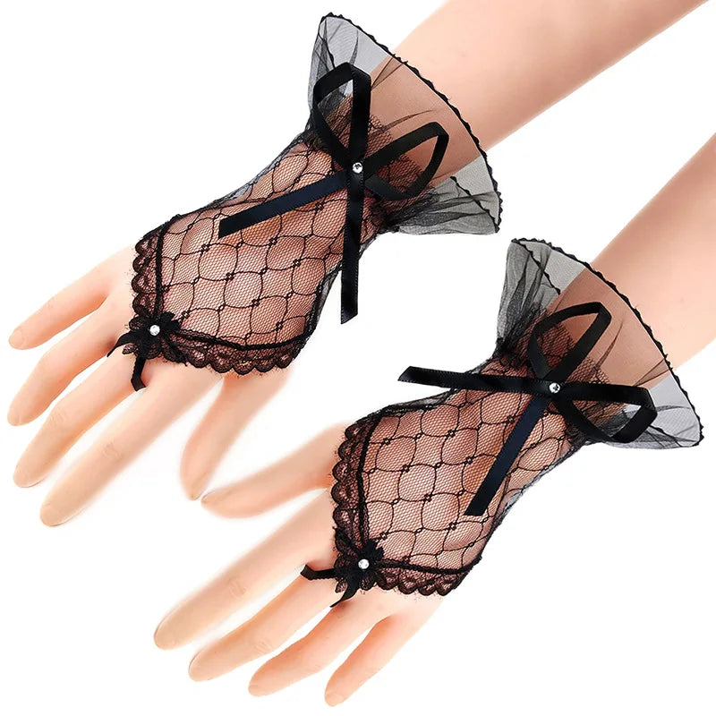 Black lace anti-sunburn arm sleeves worn on a hand and wrist.