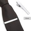 Silver elegant men's tie clip attached to a black patterned necktie.