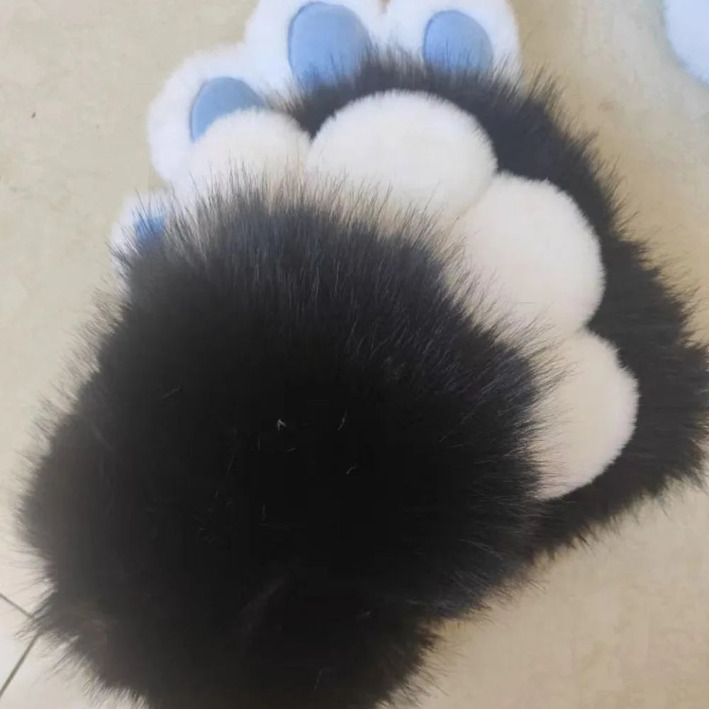 A close-up of a paw print made from black and white faux fur with light blue accents.