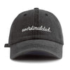 A dark gray baseball cap with white embroidered text reading overstimulated